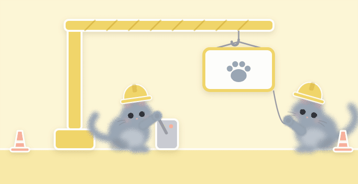 A grey cat lowering a sign with a paw print from a small crane while another steadies it